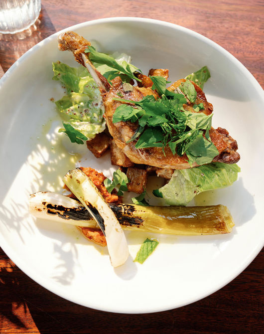 Roast duck with vegetables in a bowl on a table