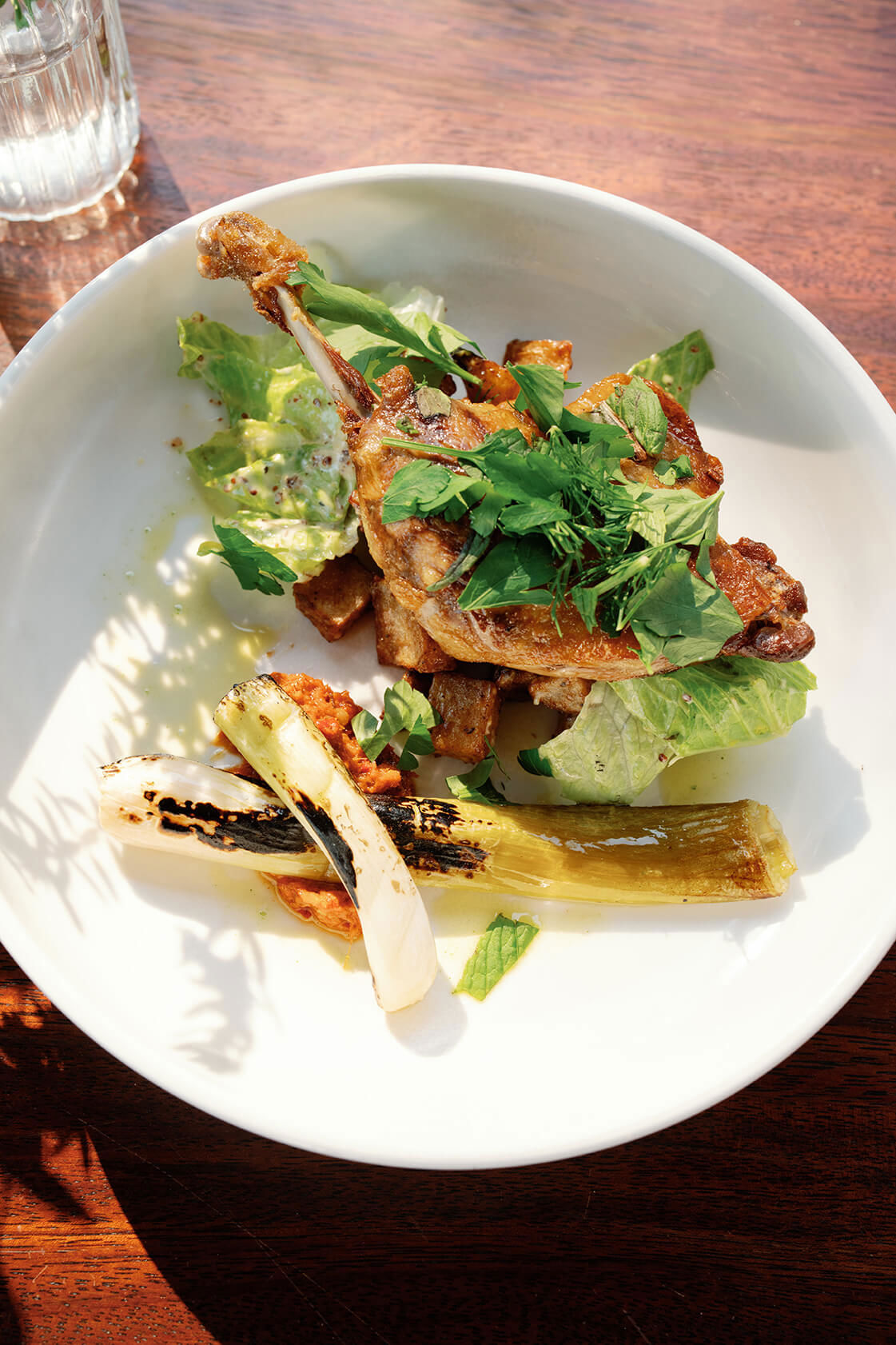 Roast duck with vegetables in a bowl on a table