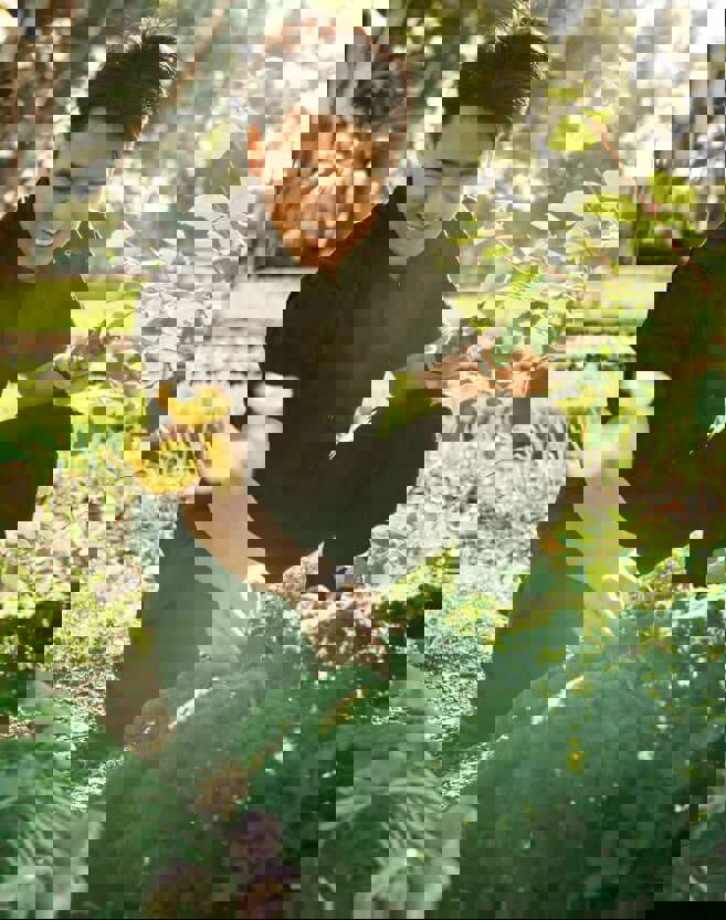 Head chef Fendi Bong picking fresh produce to use in the kitchen