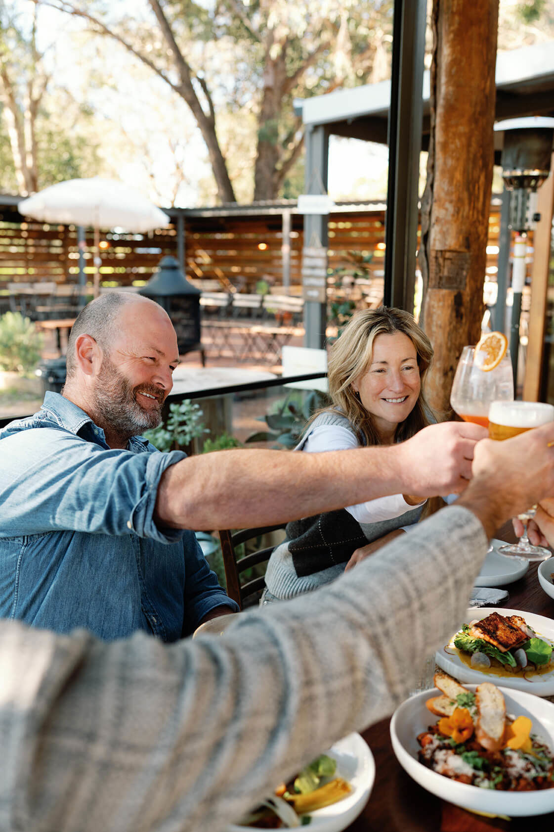 a-group-of-friends-raising-their-glasses-at-a-table.jpg